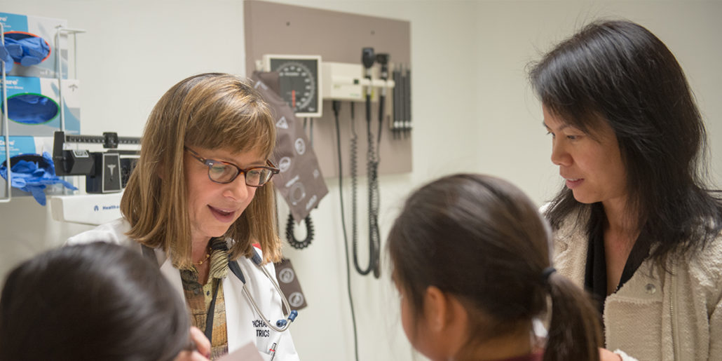 a physician consults with a patient