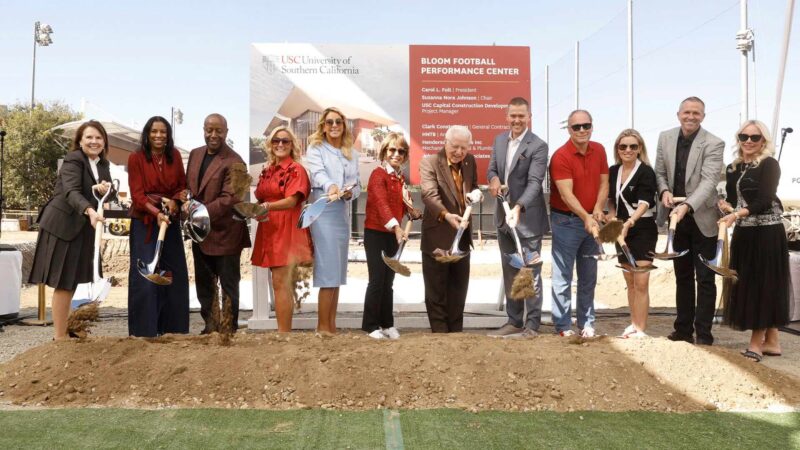 groundbreaking ceremony with many people shoveling dirt